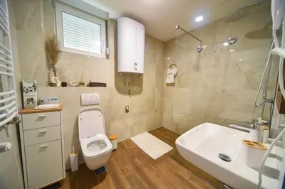 a bathroom with a toilet and a sink at BAGDALA RESIDENCE APARTMAN in Kruševac