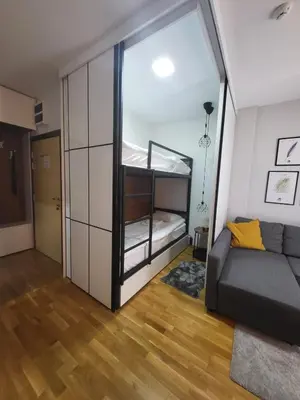 a living room with a couch and a bunk bed at Serendipity Apartment in Brzeće