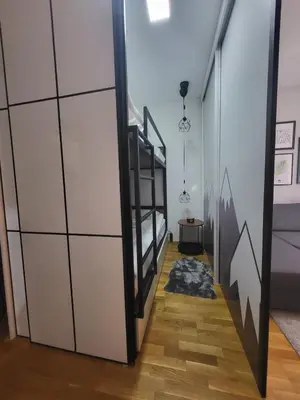 a staircase in a room with a bed at Serendipity Apartment in Brzeće