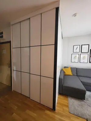 a sliding closet door in a living room with a couch at Serendipity Apartment in Brzeće