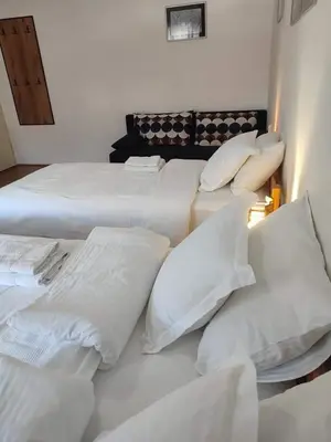 a group of white pillows sitting on a bed at B&B Vila Babin zub in Balta Berilovac