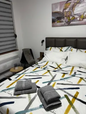 a bedroom with a bed with two towels on it at Stan na dan Kutak in Raška