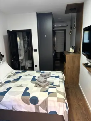 a bedroom with a bed with towels on it at Stan na dan Kutak in Raška