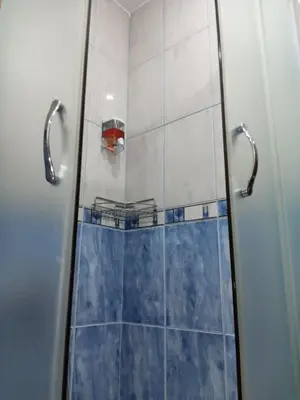 a bathroom with a shower with a glass door at Apartman Mladenovic Center, free parking&wifi in Vranje