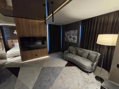 a living room with a couch and a bed at Hotel Vojvoda Putnik in Vranje