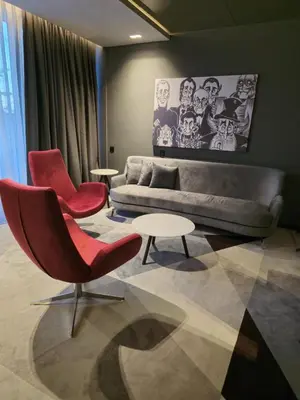 a living room with a couch and two chairs and a table at Hotel Vojvoda Putnik in Vranje