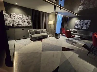 a living room with a couch and a chair at Hotel Vojvoda Putnik in Vranje