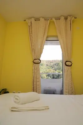 a bedroom with a bed and a window at Apartmani Ad fines in Kuršumlija