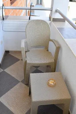 a ring sitting on a chair next to a table at Apartmani Ad fines in Kuršumlija