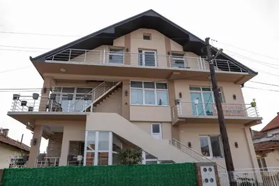 a large house with a balcony and stairs on it at SD PRENOĆIŠTE in Vranje