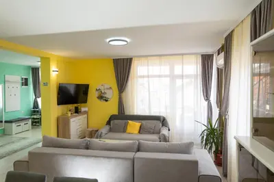 a living room with a couch and a tv at SD PRENOĆIŠTE in Vranje
