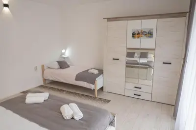 a bedroom with a bed and a dresser at SD PRENOĆIŠTE in Vranje