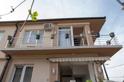 a house with a balcony on top of it at SD PRENOĆIŠTE in Vranje