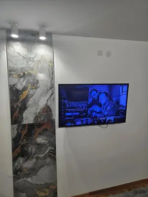 a flat screen tv hanging on a wall at Apartman Afrodita Lux 2 in Niš