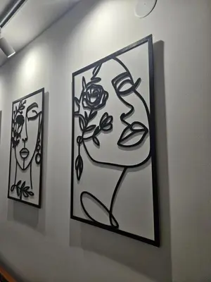 two framed drawings of a woman on a wall at Apartman Afrodita Lux 2 in Niš