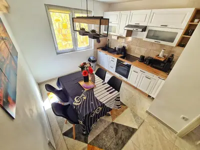 an overhead view of a kitchen with a table and chairs at Apartman Berlin Sokobanja 2 in Soko Banja