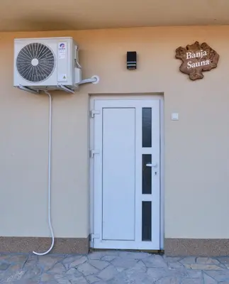 a building with a fan next to a door at Apartman Berlin Sokobanja 2 in Soko Banja