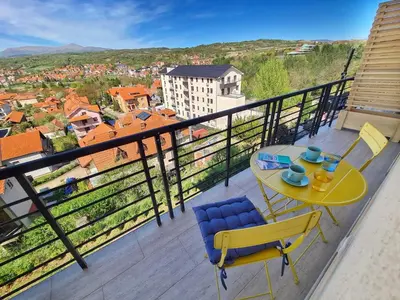 a balcony with a table and chairs and a view at Apartman Berlin Sokobanja 2 in Soko Banja