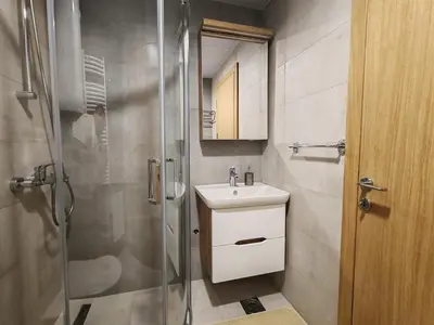 a small bathroom with a sink and a shower at Apartmani Harizma in Vrnjačka Banja