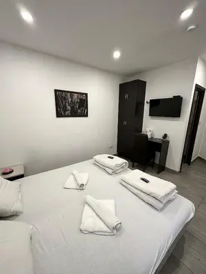 a bedroom with a bed with white towels on it at Apartmani Knez in Kruševac