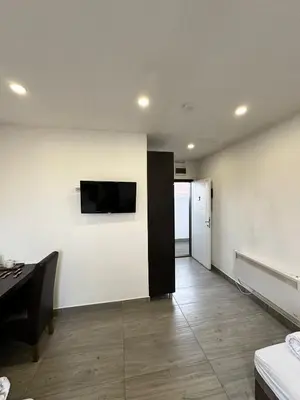 a living room with a television on a wall at Apartmani Knez in Kruševac