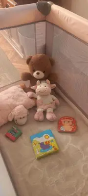 a group of stuffed animals sitting in a crib at Apartman Mila 23 Vrnjačka Banja in Vrnjačka Banja