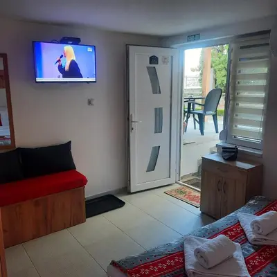 a living room with a couch and a tv on the wall at AGAPE in Leskovac