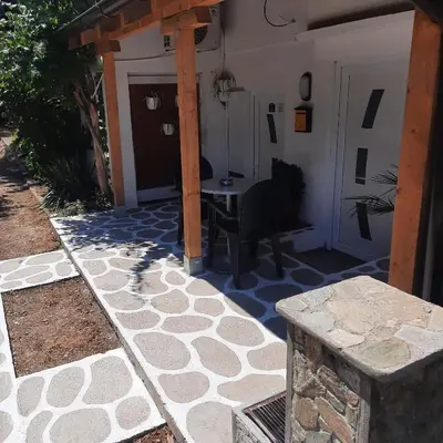 a patio with a table and a house at AGAPE in Leskovac