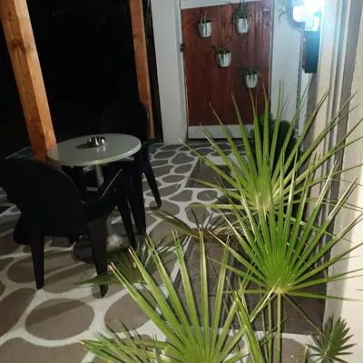 a room with a table and two potted plants at AGAPE in Leskovac