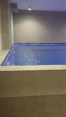 a large blue swimming pool in a building at Jigy Kop in Kopaonik