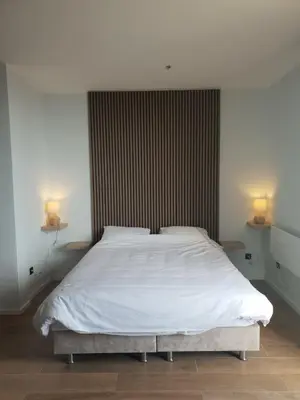 a bedroom with a white bed with two lamps at Jigy Kop in Kopaonik
