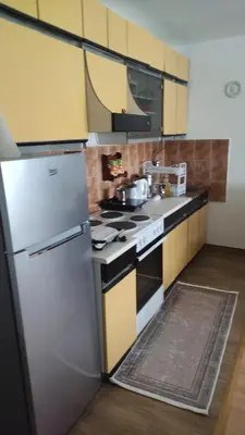 a kitchen with a refrigerator and a stove at Apartman NINASTA in Pirot