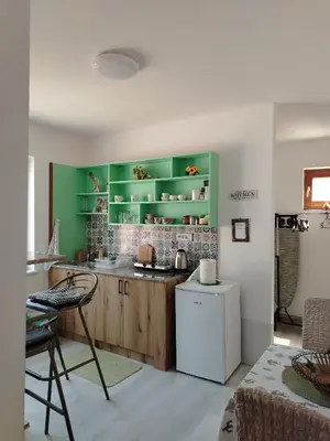 a kitchen with green cabinets and a white refrigerator at Passage in Paraćin