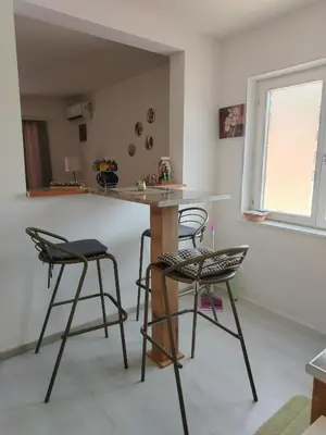 a kitchen with two bar stools and a counter at Passage in Paraćin
