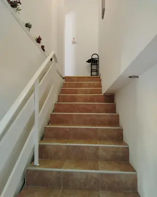 a staircase in a house with brown stairs at Passage in Paraćin
