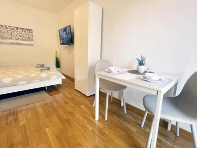 a room with a table and chairs and a bed at Studio GAGI in Vrnjačka Banja
