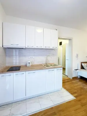 a kitchen with white cabinets and a sink at Studio GAGI in Vrnjačka Banja