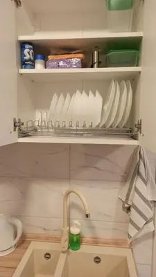 a kitchen with a sink and a shelf with dishes at Studio GAGI in Vrnjačka Banja