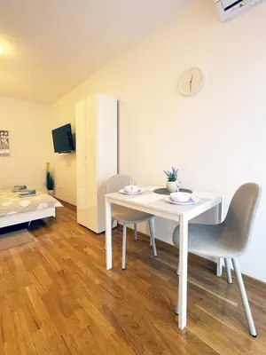 a room with a table and chairs and a bed at Studio GAGI in Vrnjačka Banja