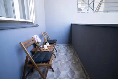 a room with two chairs and a table and a window at Studio Iris 2 in Niš