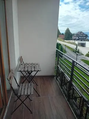 a table and chairs on a balcony with a view at Studio Ristic Milmari L5 in Kopaonik