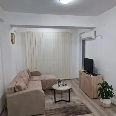 a living room with a couch and a tv at Emili lux in Jagodina