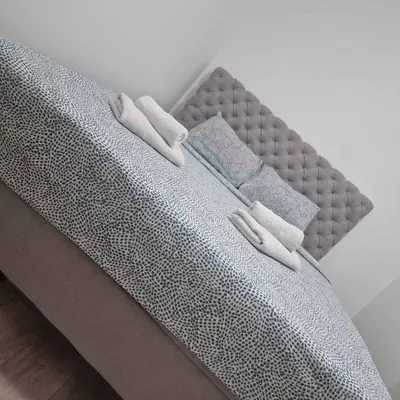 a bed with three pillows on top of it at Emili lux in Jagodina