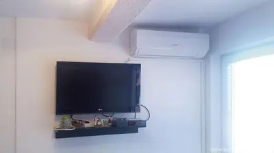 a flat screen tv on a wall in a room at Apartman Pazova in Soko Banja
