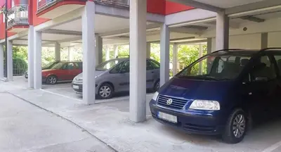 a group of cars parked in a parking lot at Apartman Pazova in Soko Banja