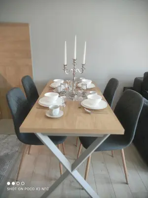 a wooden table with black chairs and a dining room at Central Lux ( U CENTRU GRADA, 30m od SPA centra) in Soko Banja