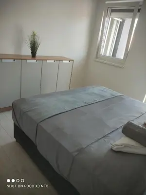 a large bed in a bedroom with a window at Central Lux ( U CENTRU GRADA, 30m od SPA centra) in Soko Banja