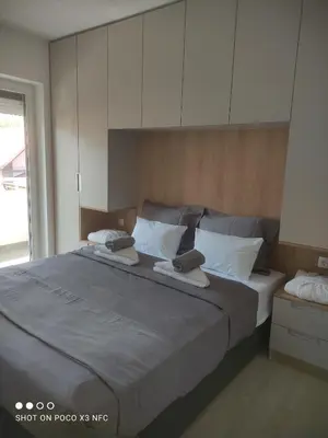 a bedroom with a large bed with white pillows at Central Lux ( U CENTRU GRADA, 30m od SPA centra) in Soko Banja