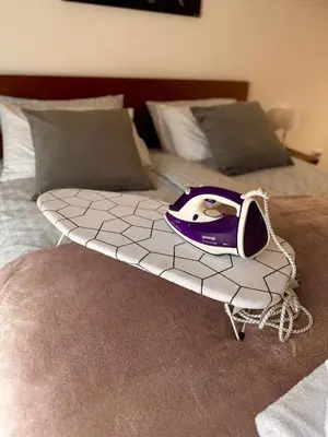 avisor sitting on top of a bed at Apartmani Viver Vrnjačka Banja in Vrnjci