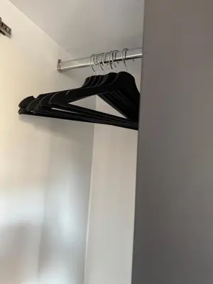 a rack of black shirts hanging on a wall at Apartmani Viver Vrnjačka Banja in Vrnjci